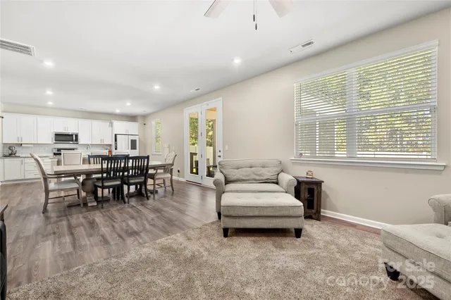 a living room with furniture and a dining table