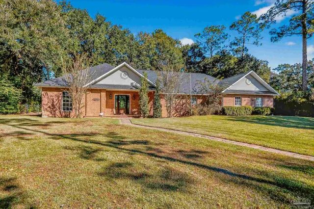 a view of yard with swimming pool and trees