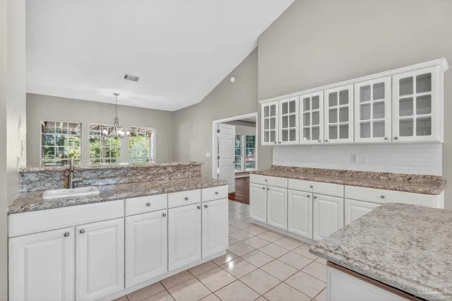 a kitchen with stainless steel appliances granite countertop a sink stove and cabinets
