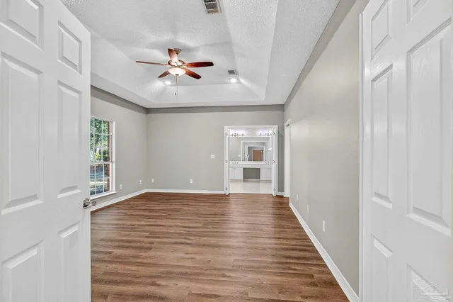 a large bathroom with a double vanity sink a toilet and a large mirror