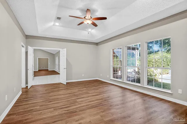 a view of room with window and wooden floor