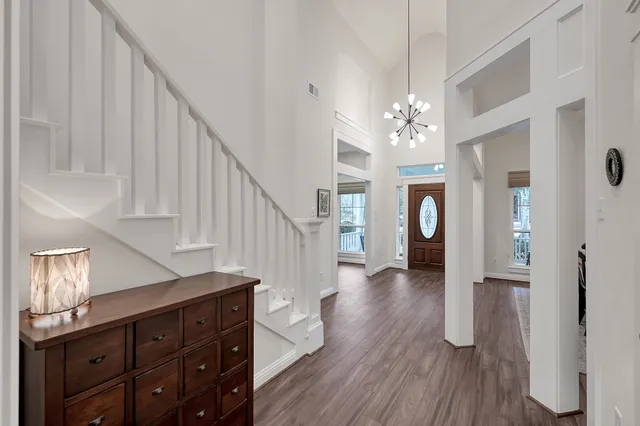 a view of entryway and hall with wooden floor
