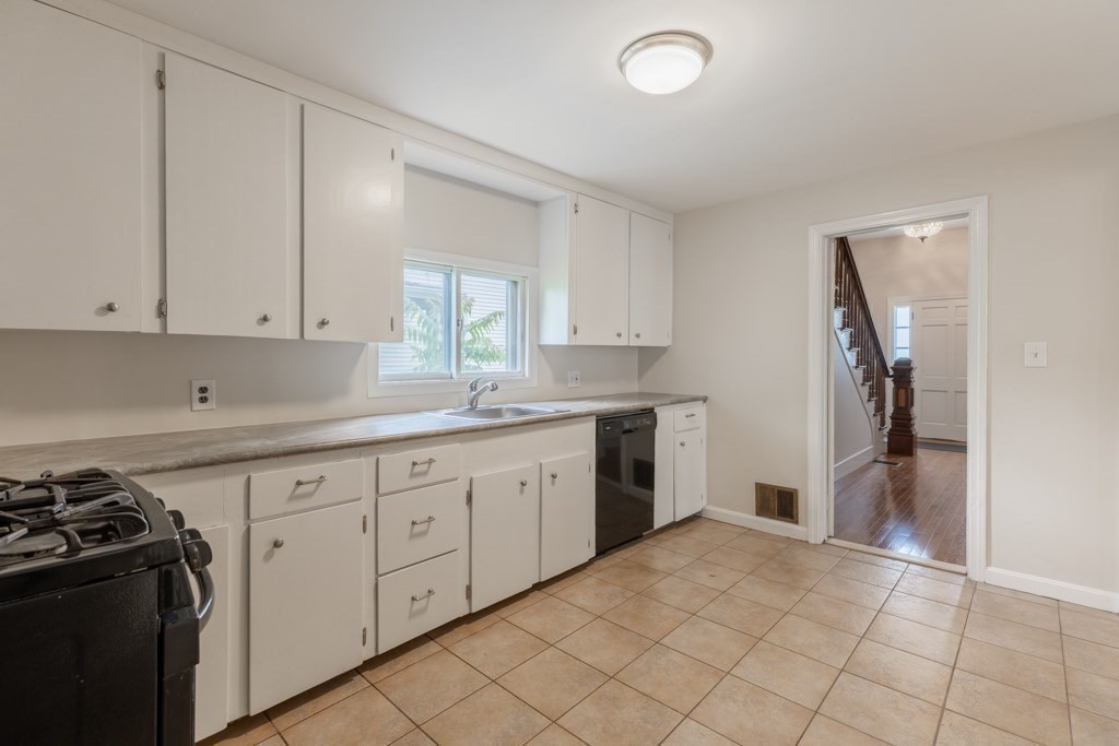 55 Morse Street, Unit 1 Watertown, MA 02472 - Photo 3 of 12 a kitchen with a sink stove and refrigerator