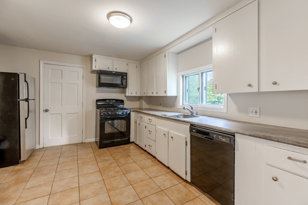 55 Morse Street, Unit 1 Watertown, MA 02472 - Photo 4 of 12 a kitchen with a stove top oven sink and cabinets