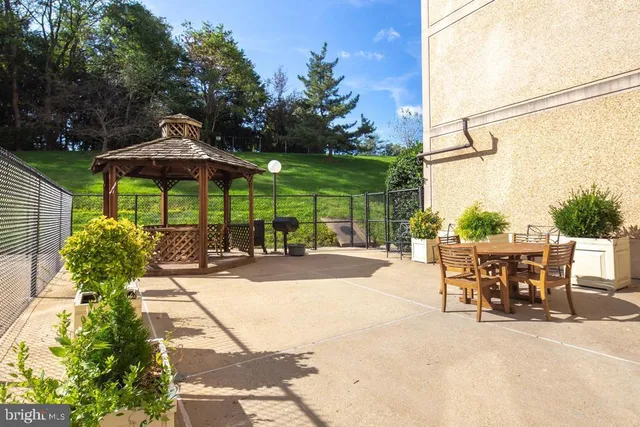 a view of a patio with a table and chairs under an umbrella