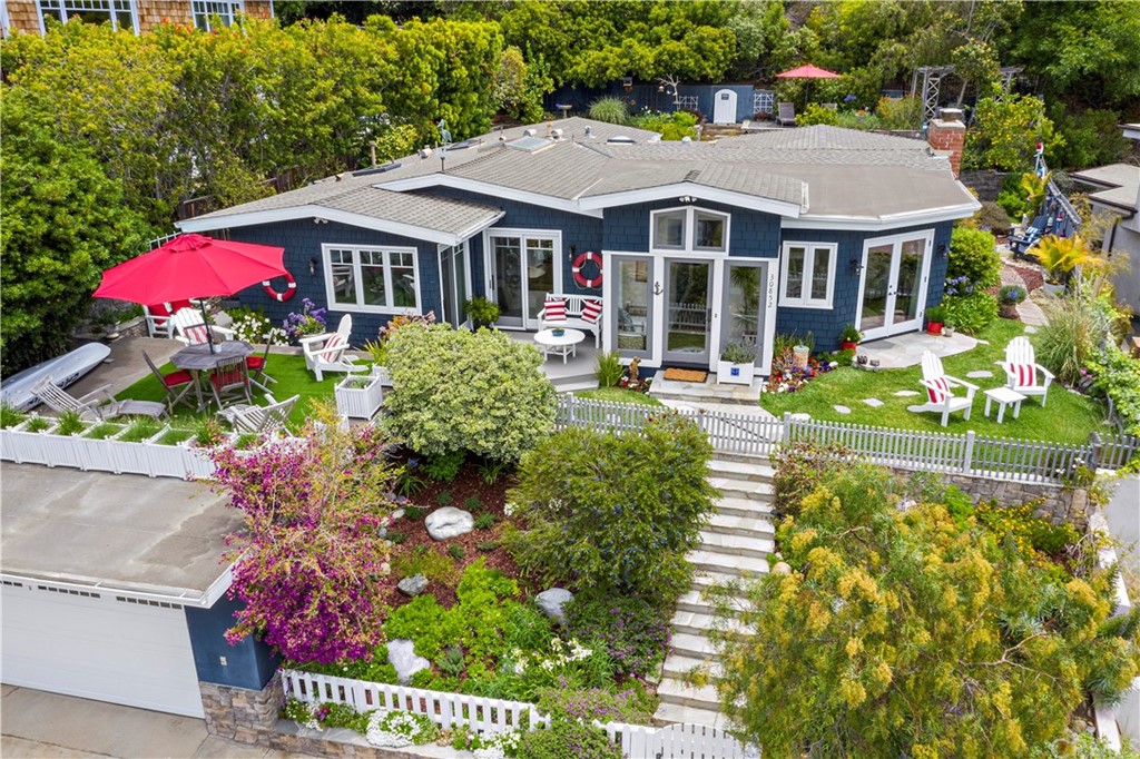 a front view of a house with a yard and a garden