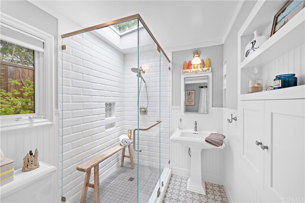 30852 Driftwood Drive Laguna Beach, CA 92651 - Photo 28 of 54 a bathroom with a sink and mirror with bathtub