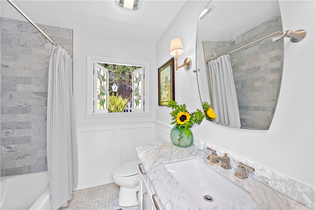 30852 Driftwood Drive Laguna Beach, CA 92651 - Photo 29 of 54 a bathroom with a sink mirror vanity and toilet