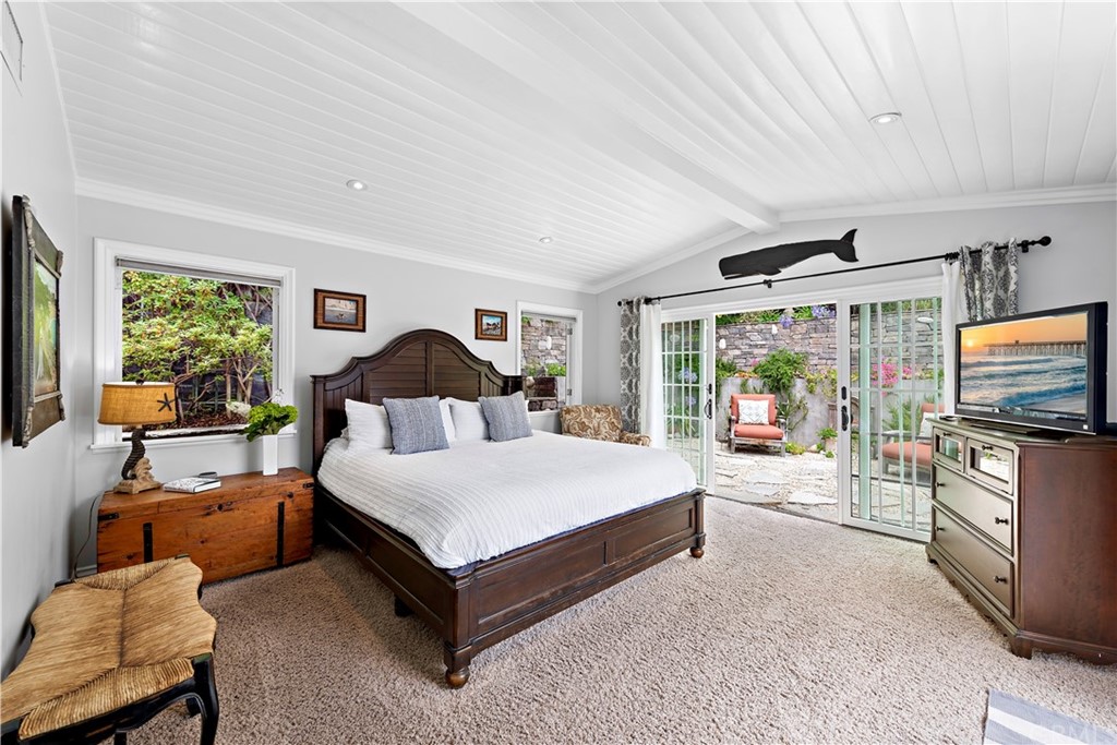 30852 Driftwood Drive Laguna Beach, CA 92651 - Photo 30 of 54 a spacious bedroom with a bed and a flat screen tv