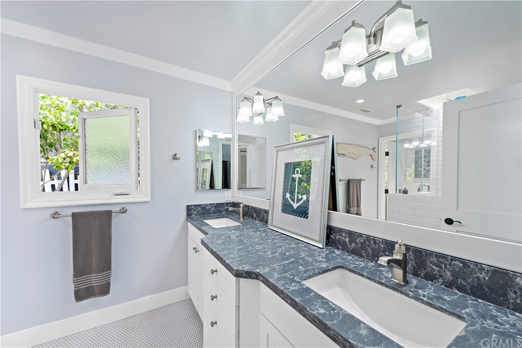 30852 Driftwood Drive Laguna Beach, CA 92651 - Photo 33 of 54 a bathroom with a granite countertop double vanity sink and a mirror