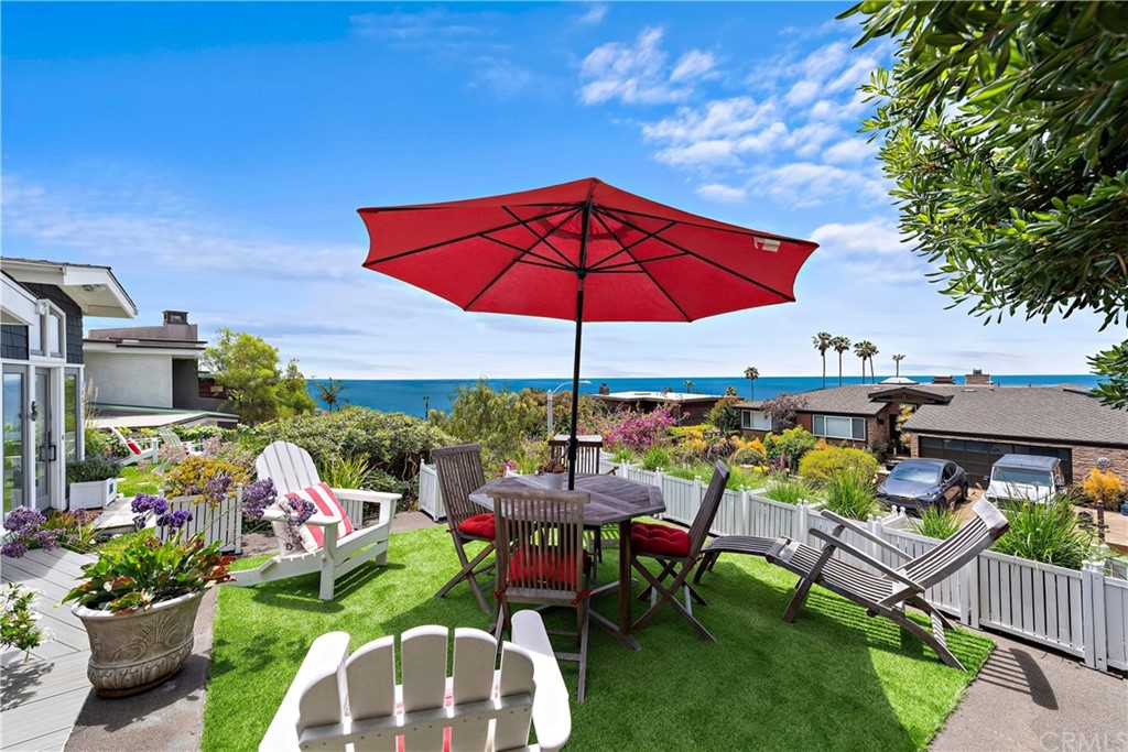 30852 Driftwood Drive Laguna Beach, CA 92651 - Photo 9 of 54 a view of a chairs and table under an umbrella in backyard