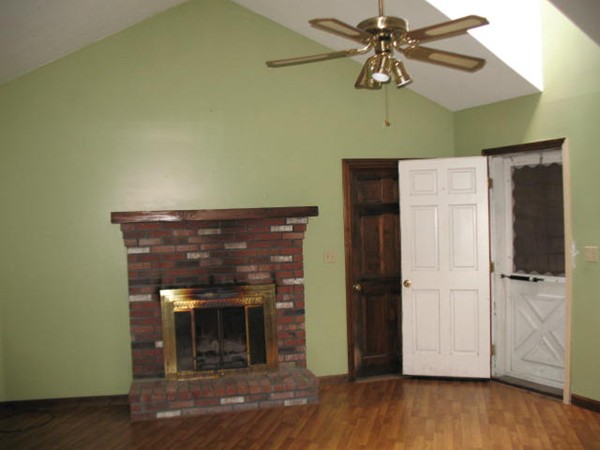 33 Douglas Road Dracut, MA 01826 - Photo 7 of 25 a view of a livingroom with a fireplace and wooden floor