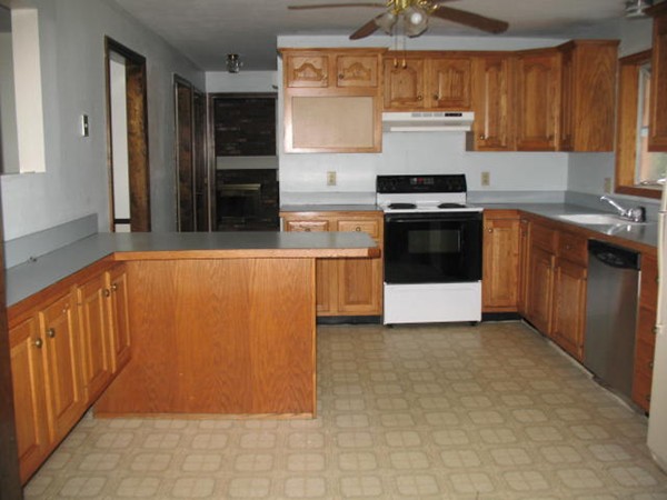 33 Douglas Road Dracut, MA 01826 - Photo 9 of 25 a kitchen with stainless steel appliances a stove and a refrigerator