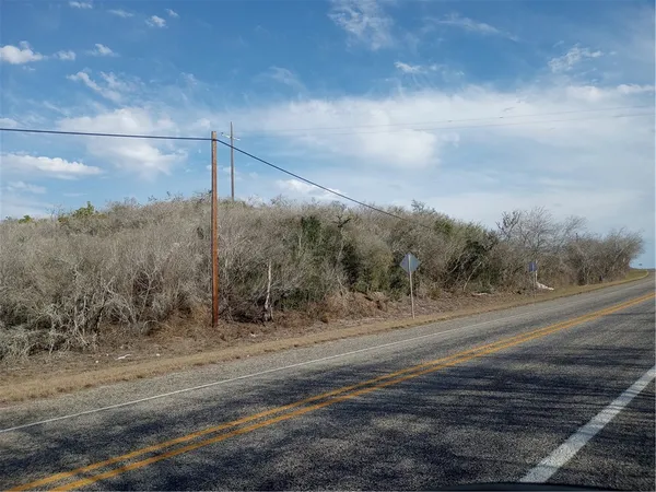 a view of a road with a dry yard