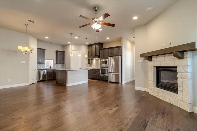 a view of a living room a kitchen and a fireplace