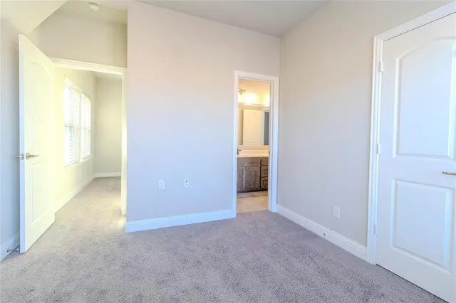 an empty room with a bathroom and sink