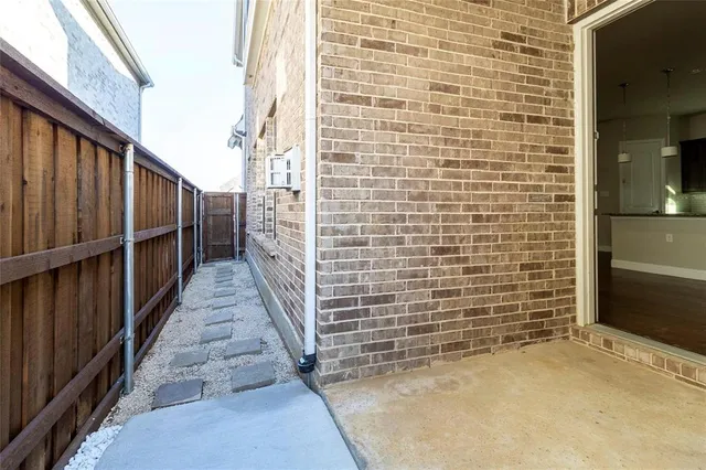 a view of an empty room with wooden floor and stairs