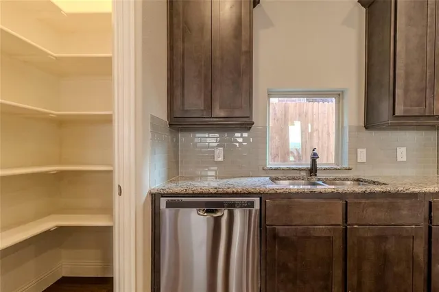 a kitchen with granite countertop a sink and a window