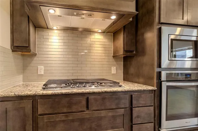 a stove top oven sitting inside of a kitchen