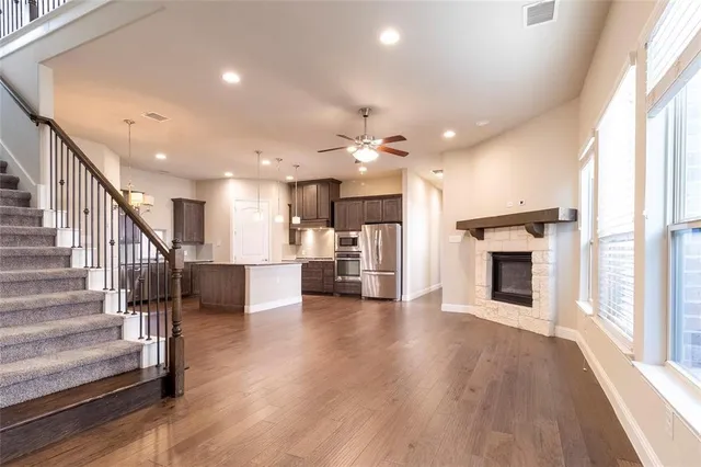 a view of a living room a fireplace with wooden floor and windows