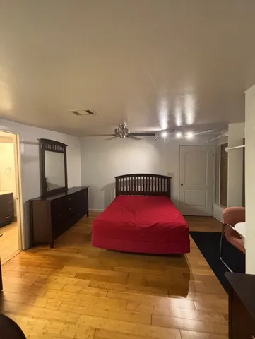 a spacious bedroom with a bed and a couch