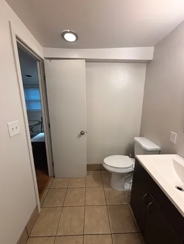 a bathroom with a sink a toilet and a shower