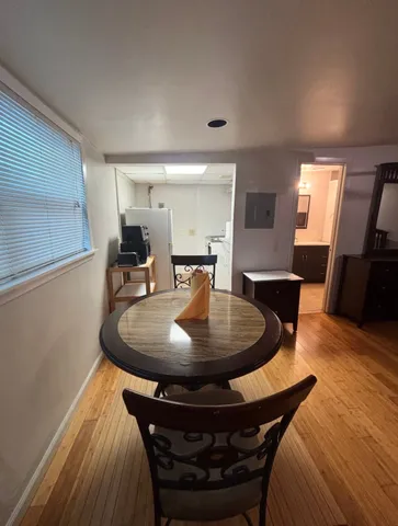 a dining room with furniture and wooden floor