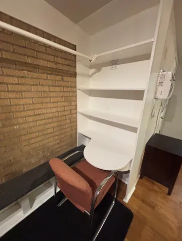 a view of a room with table and a chair