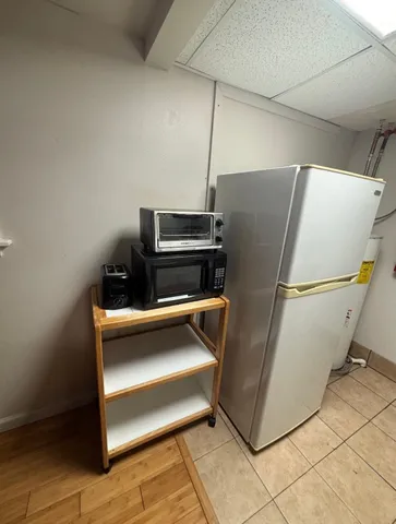 a refrigerator freezer sitting inside of a kitchen