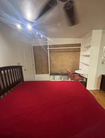 a bedroom with a bed and a window