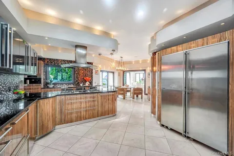a view of a patio with furniture and floor to ceiling window