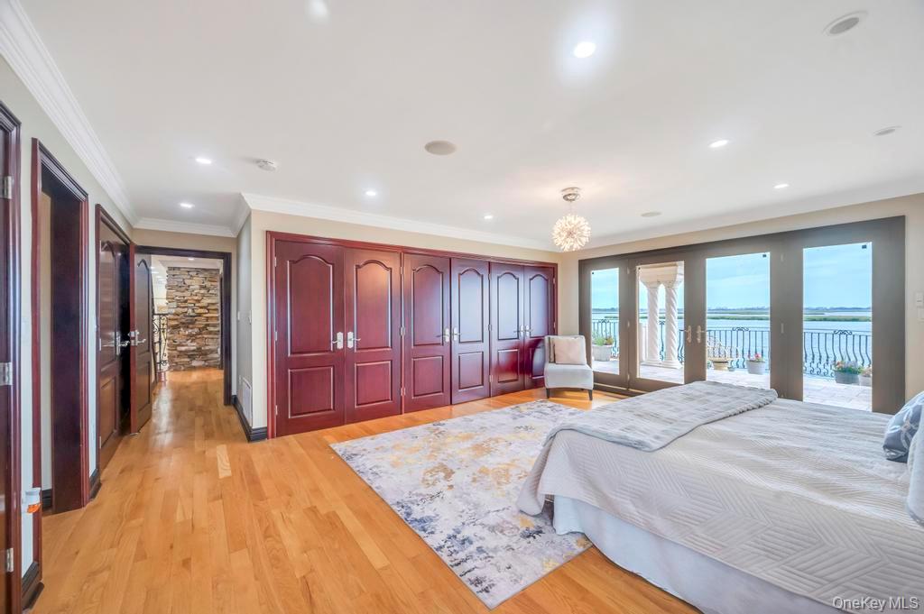 1101 Harbor Road Hewlett, NY 11557 - Photo 18 of 46 a spacious bedroom with a large bed and a dresser