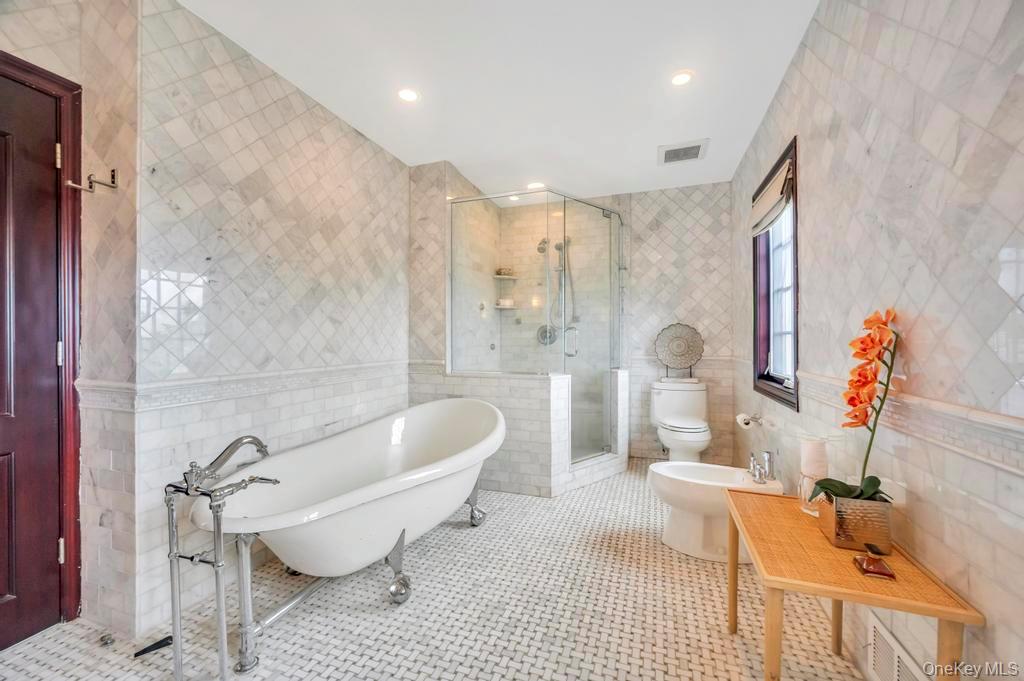 1101 Harbor Road Hewlett, NY 11557 - Photo 19 of 46 a spacious bathroom with a granite countertop tub and a shower