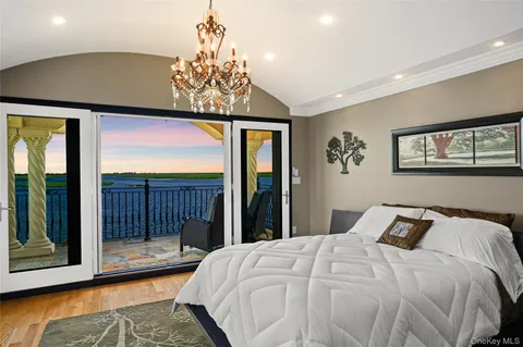 a spacious bedroom with a large bed and a large window