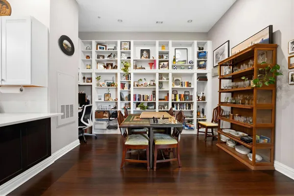 a view of a livingroom with furniture and bookshelf