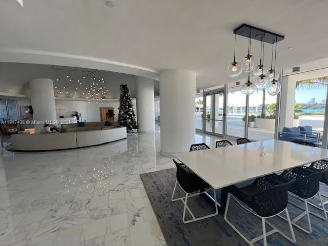 a living room with furniture and a pool table