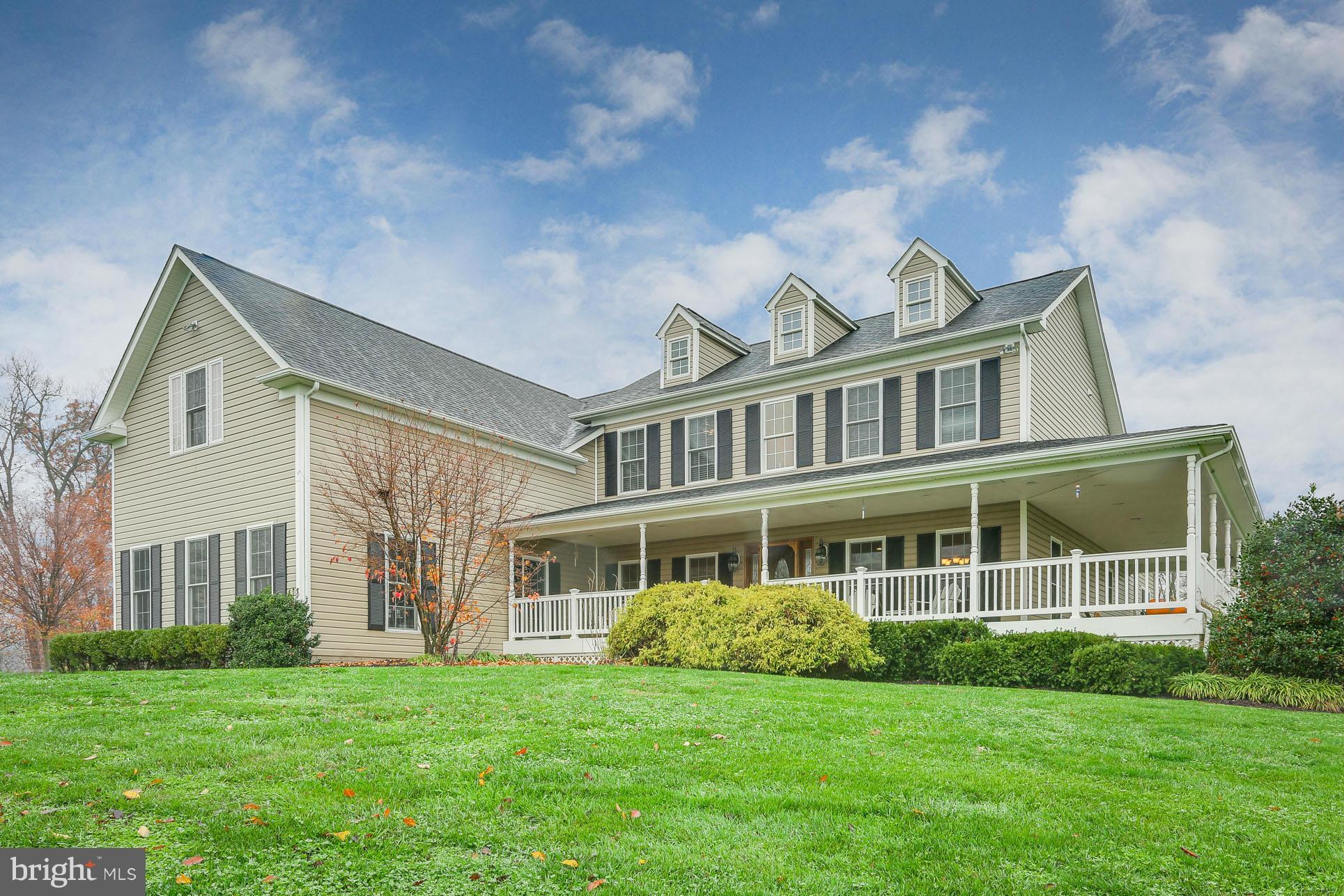 8490 Mapleville Road Mount Airy, MD 21771 - Photo 1 of 30 a front view of a house with a garden