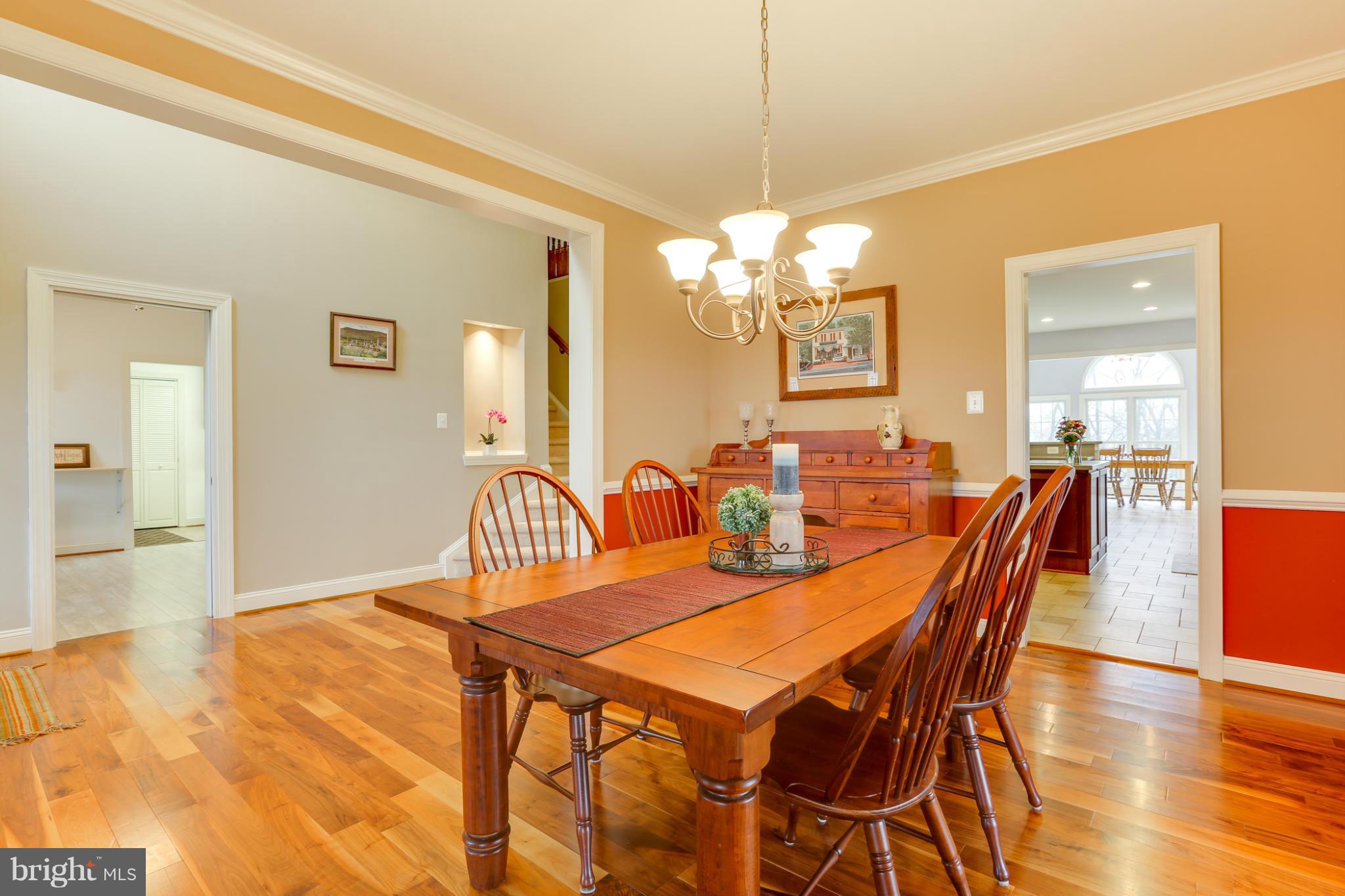 8490 Mapleville Road Mount Airy, MD 21771 - Photo 11 of 30 a dining room with furniture a chandelier and wooden floor