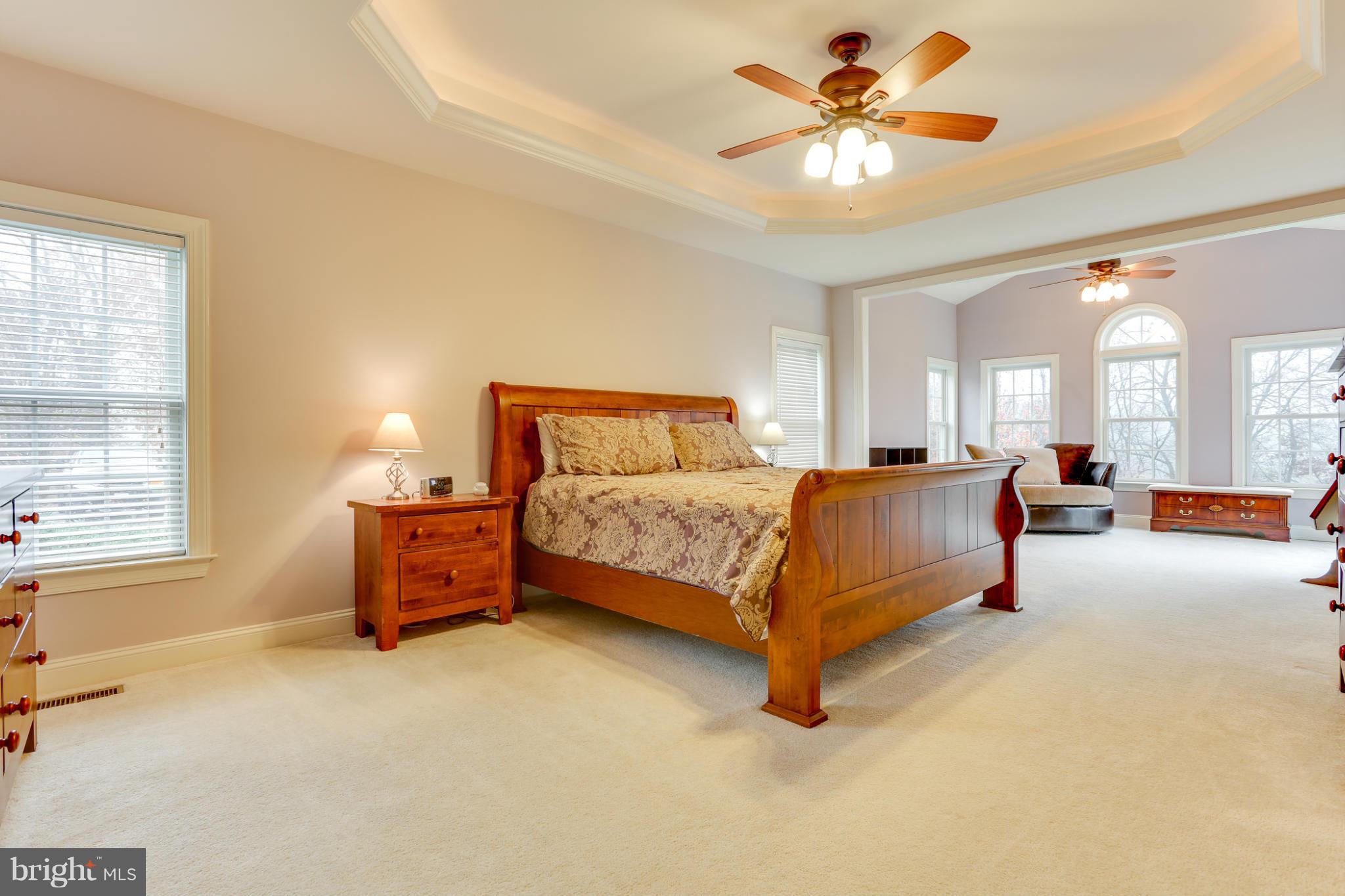 8490 Mapleville Road Mount Airy, MD 21771 - Photo 22 of 30 a bedroom with a bed and a chandelier