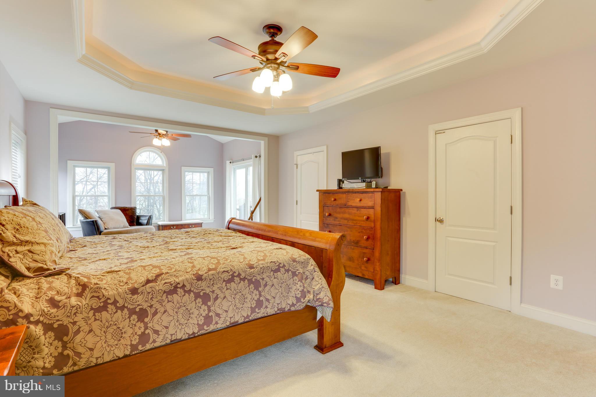 8490 Mapleville Road Mount Airy, MD 21771 - Photo 23 of 30 a bedroom with a bed and a chandelier