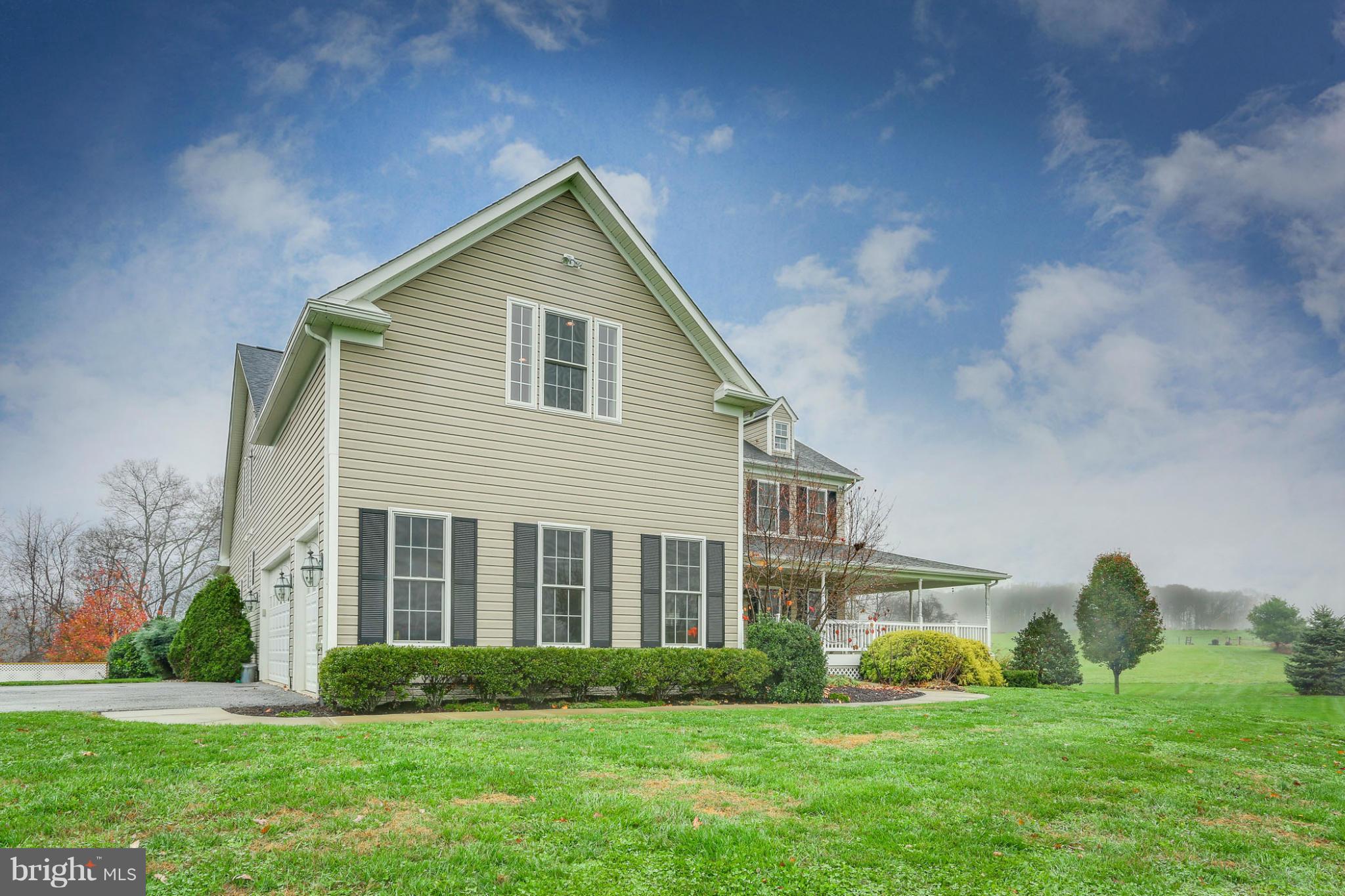 8490 Mapleville Road Mount Airy, MD 21771 - Photo 6 of 30 a front view of a house with a yard and trees