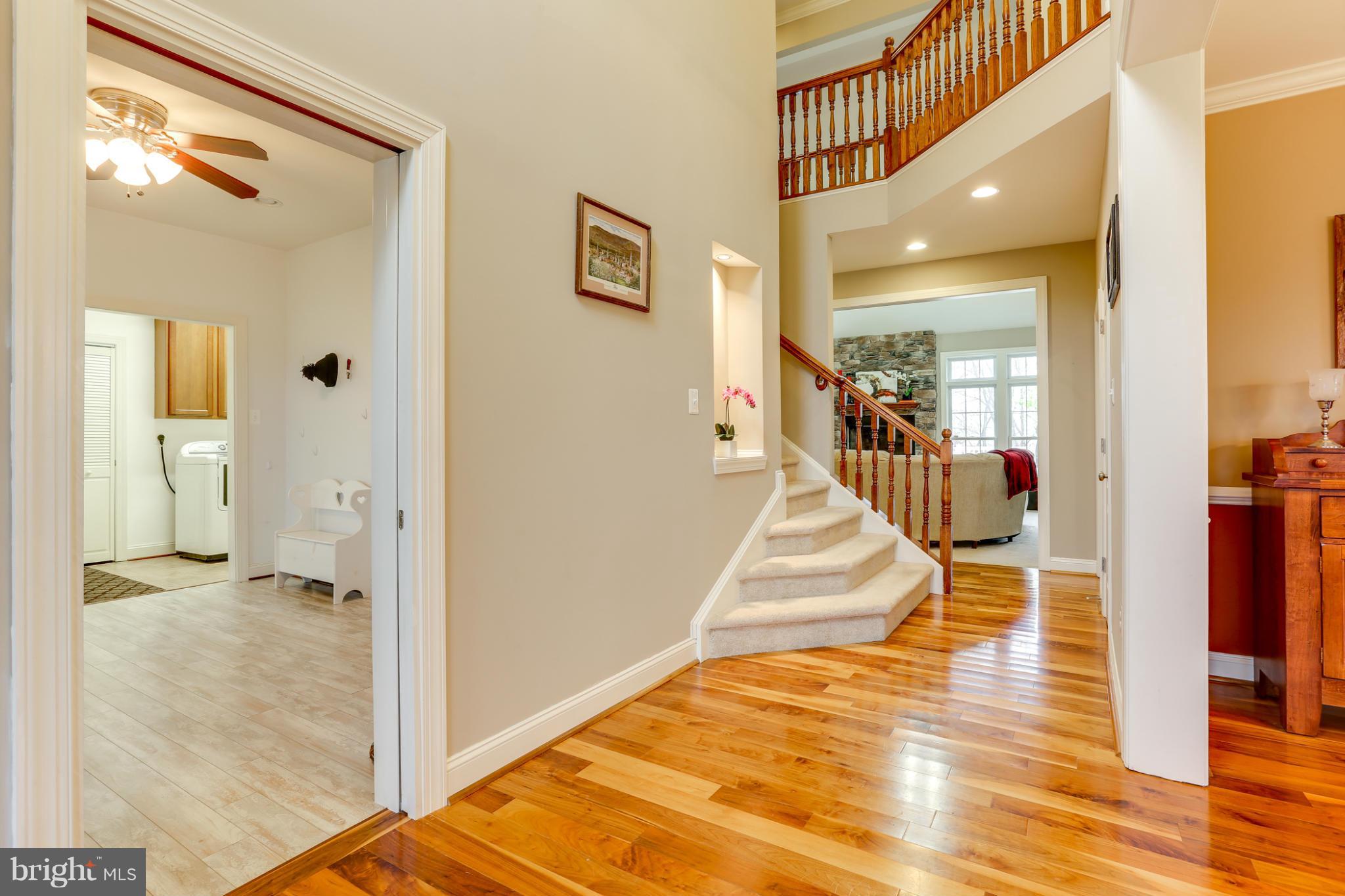 8490 Mapleville Road Mount Airy, MD 21771 - Photo 9 of 30 a view of a hallway with wooden floor and a living room