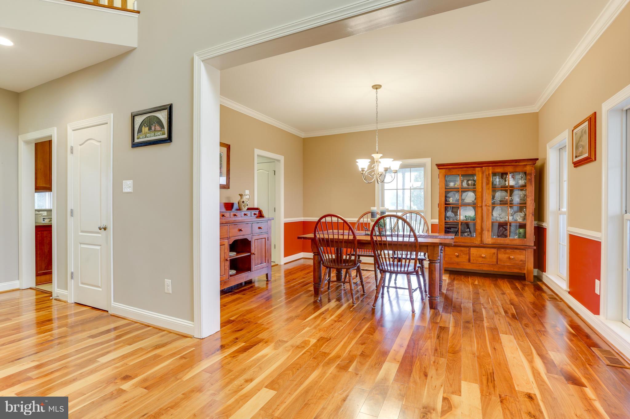 8490 Mapleville Road Mount Airy, MD 21771 - Photo 10 of 30 a view of a dining room with furniture and wooden floor