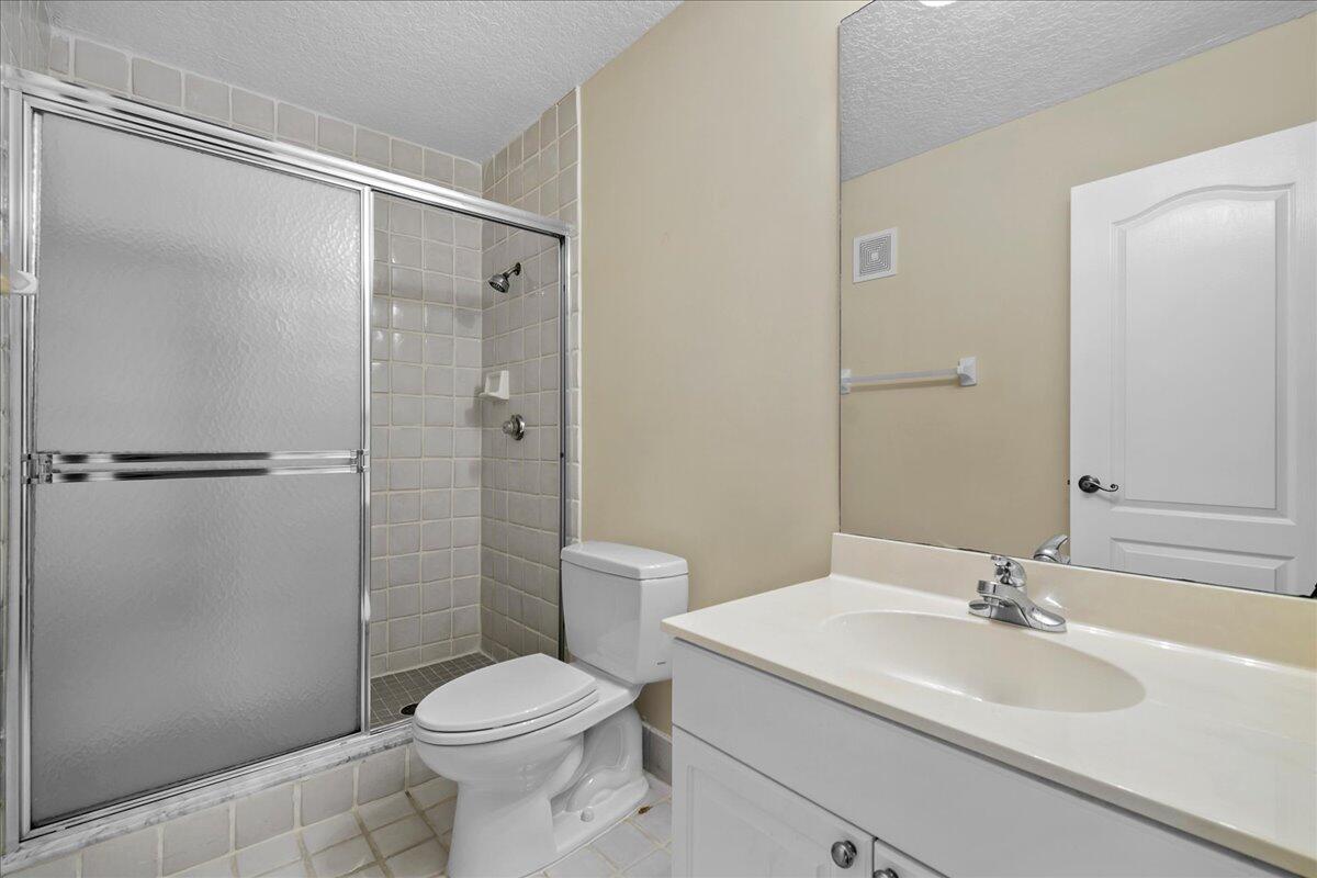 41 Uno Lago Drive Juno Beach, FL 33408 - Photo 11 of 31 a bathroom with a sink toilet and shower