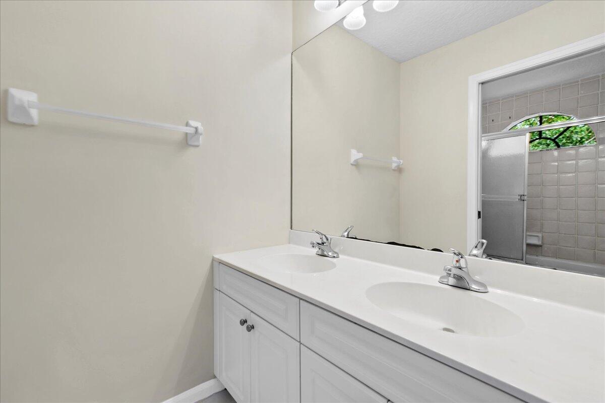 41 Uno Lago Drive Juno Beach, FL 33408 - Photo 16 of 31 a bathroom with a sink and a mirror
