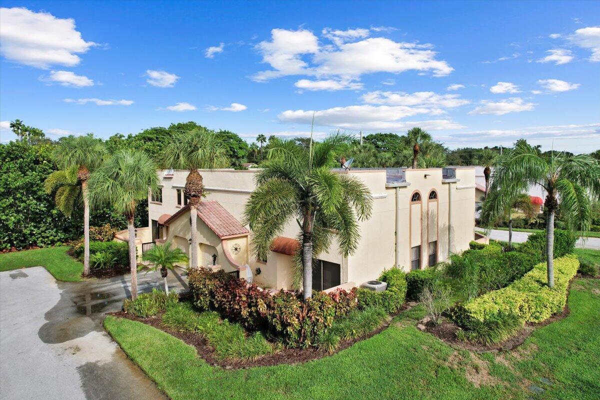 41 Uno Lago Drive Juno Beach, FL 33408 - Photo 21 of 31 front view of a house with a yard