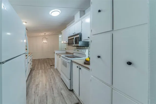 a kitchen with stainless steel appliances a refrigerator and a stove top oven