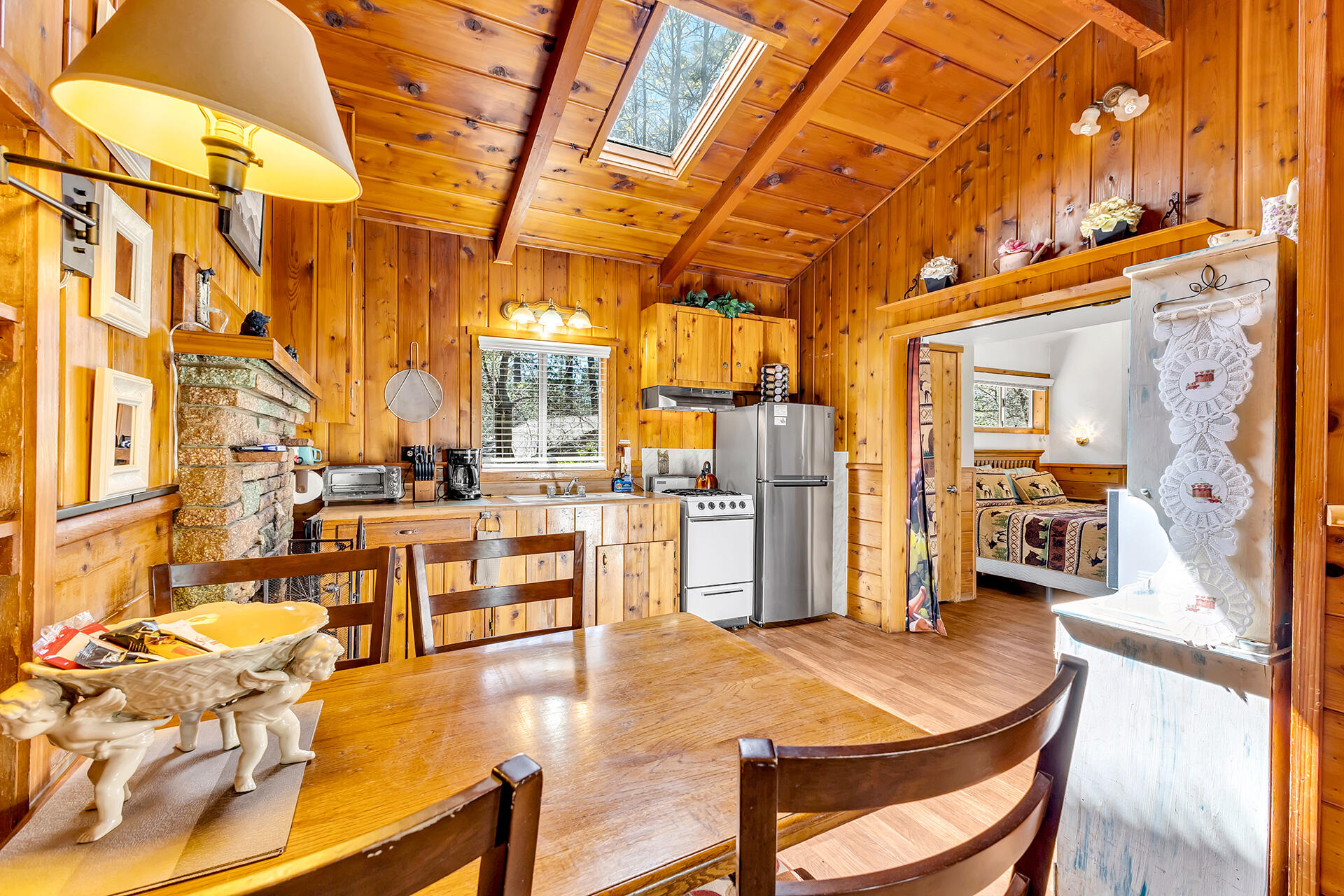 53460 Tollgate Road Idyllwild, CA 92549 - Photo 8 of 37 a dining room with stainless steel appliances kitchen island granite countertop a table and chairs