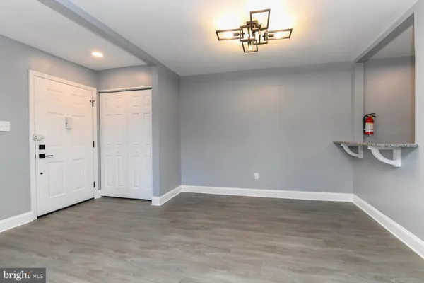 a view of a livingroom with wooden floor and furniture