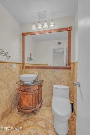 a bathroom with a toilet a sink and mirror